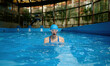 © Nomad_Soul - Shot in motion of young woman emerging from water in indoor swimming pool