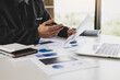 © Wasan - Businessman working on documents analyzing financial charts in business reports, finance and accounting.