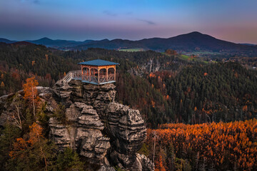 Wall Mural - Jetrichovice, Czech Republic - Aerial view of Mariina Vyhlidka (Mary's view) lookout with a beautiful Czech autumn landscape and colorful sunset sky in Bohemian Switzerland region