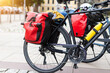 Many modern bicycles with travel luggage bags equipment parked in old european city center street. Healthy eco sustainable tourism family trip lifestyle. Bike hobby adventure tour journey