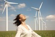 © Road Red Runner - Relaxed woman in a field, walking, in the background field of wind turbines produce electricity with the wind. Ai generated.