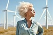 © Road Red Runner - Relaxed woman strolls through the field, the background showcases  wind turbines producing clean and sustainable electricity. Ai generated.