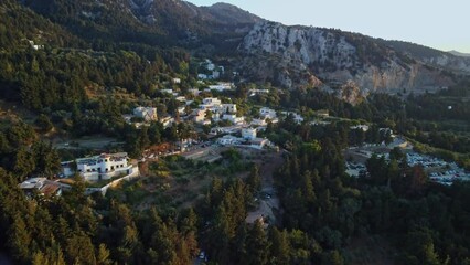 Poster - Village Zia on the island of Kos, Greece, surrounded by trees, with a mountain in the background