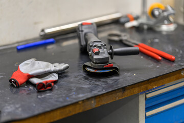 Wall Mural - Electric battery grinder on the work table.