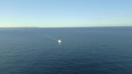 Sticker - Aerial video of the white boat on the crystal clear sea and the shore, Malta