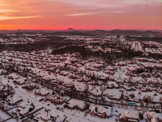 Sticker - Aerial view of a snowy town under a dusk sky