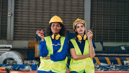 Wall Mural - Portrait of Industrial technicians or The foramen will examine and check up on the machinery in the manufacturing facility. Technician working in the metal sheet business at a company.