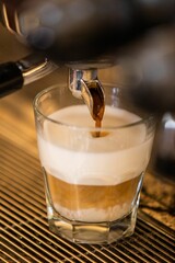 Sticker - Closeup of a glass of coffee making from machine