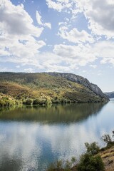 Poster - Beautiful landscape of a river between green hills on a sunny day