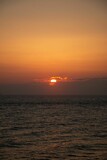 Fototapeta  - Vertical shot of a beautiful sunset over the Adriatic sea on an Italian shore