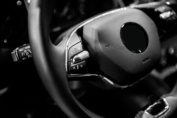 Poster - Closeup shot of a black steering wheel of the car