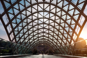 Close-up of a beautiful glass-to-steel footbridge with a glass roof.