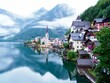 Breathtaking postcard view of buildings and Hallstatter See in Hallstatt, Austria on foggy day