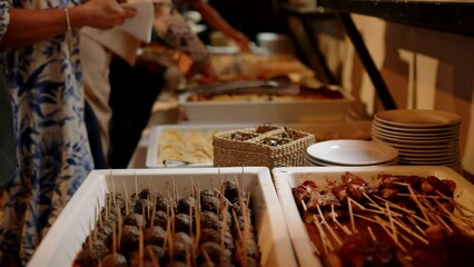 Wall Mural - Closeup of people standing in front of cakes