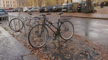 Sticker - Closeup of old bicycles in the street on a rainy day in Oslo, Norway