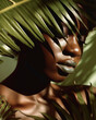 © TRINETTE + CHRIS - Make-up beauty portrait of Black woman with nature green leaves. Generative AI.