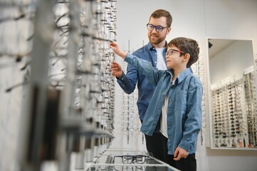 Wall Mural - Father with cute son. Family buy glasses