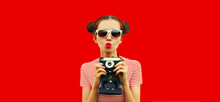 Portrait Of Happy Young Woman Photographer With Film Camera, Female With Cool Girly Hairstyle On Red Background