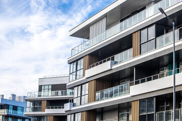 modern, opulent apartment. A contemporary residential complex in the sunlight. An housing complex in white with a blue sky. A contemporary apartment building's facade