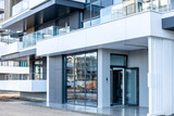 Fototapeta  - new building facade , windows and house entrance on apartment house exterior