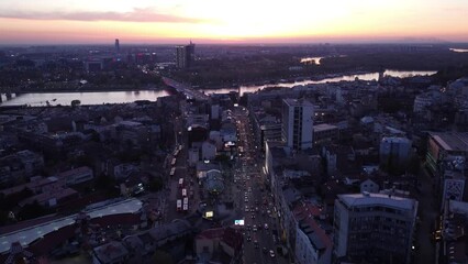 Poster - Aerial view of roads and buildings in a city on the sunset