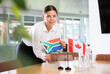 © JackF - Young woman in business clothes puts flags of South Africa and Canada on negotiating table in office