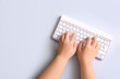 © Pixel-Shot - Female hands with modern computer keyboard on light background