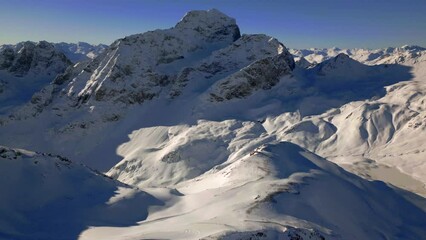 Wall Mural - Beautiful footage of Snow covered snowy range mountains and blue sky in the winter