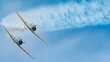 © Mikhail Koretskiy/Wirestock Creators - Two airplanes flying in the blue skies during an air show in bright sunlight with a copy space