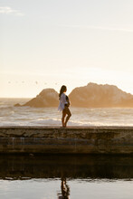 Beautiful Pregnant Woman Standing On PIer At Ocean