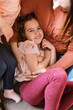 © Serena Burroughs/Stocksy - Mother cuddling with her daughter on sofa