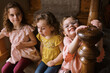 © Serena Burroughs/Stocksy - Three sisters sitting on stairs in home