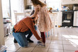 © Serena Burroughs/Stocksy - Mother helping her daughter put her shoes on