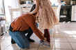 © Serena Burroughs/Stocksy - Mother helping her daughter put her shoes on