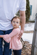 © Serena Burroughs/Stocksy - little girl standing outdoors in winter hugging her dad