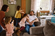 © Serena Burroughs/Stocksy - Family playing in living room together