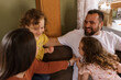 © Serena Burroughs/Stocksy - Family playing in living room together