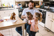 © Serena Burroughs/Stocksy - Cute happy toddler girl holding up her pet cat at home in kitchen