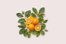 Fresh Tangerines, Whole And Cut In Half With Green Leaves.