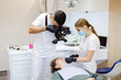 © Oleksii Syrotkin/Stocksy - X-ray procedure scan device odontology nurse patient teeth examination