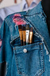 © Viktor Solomin/Stocksy - Woman with painting brush in jeans jacket pocket closeup