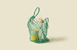 © Yaroslav Danylchenko/Stocksy - Mesh bag with reusable cup and stylish bottle.