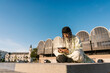 © Ezequiel Giménez/Stocksy - Stylish female using smartphones in city