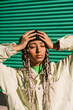 © Ezequiel Giménez/Stocksy - Woman with closed eyes near green wall