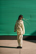© Ezequiel Giménez/Stocksy - Woman dancing near green building