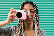 © Ezequiel Giménez/Stocksy - Calm Indian woman taking photo with smartphone camera