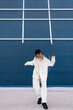 © Ezequiel Giménez/Stocksy - Active woman dancing with raised hands and looking down