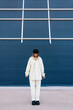 © Ezequiel Giménez/Stocksy - Serious woman standing on street and looking down