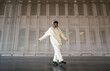 © Ezequiel Giménez/Stocksy - Stylish woman dancing in hangar