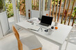 © Stereo Shot/Stocksy - White table with netbook on veranda